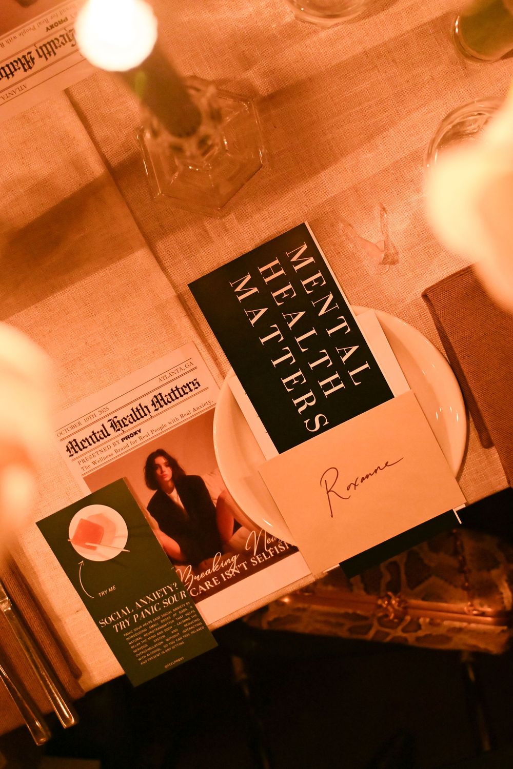 Business cards arranged in a row with warm orange lighting creating an atmospheric professional display.
