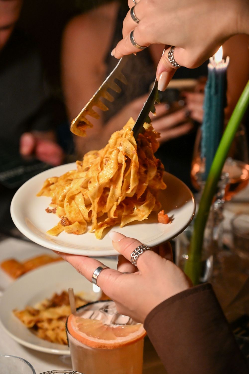 A sequence of photos showing crispy onion rings being placed on a plate at a restaurant table.