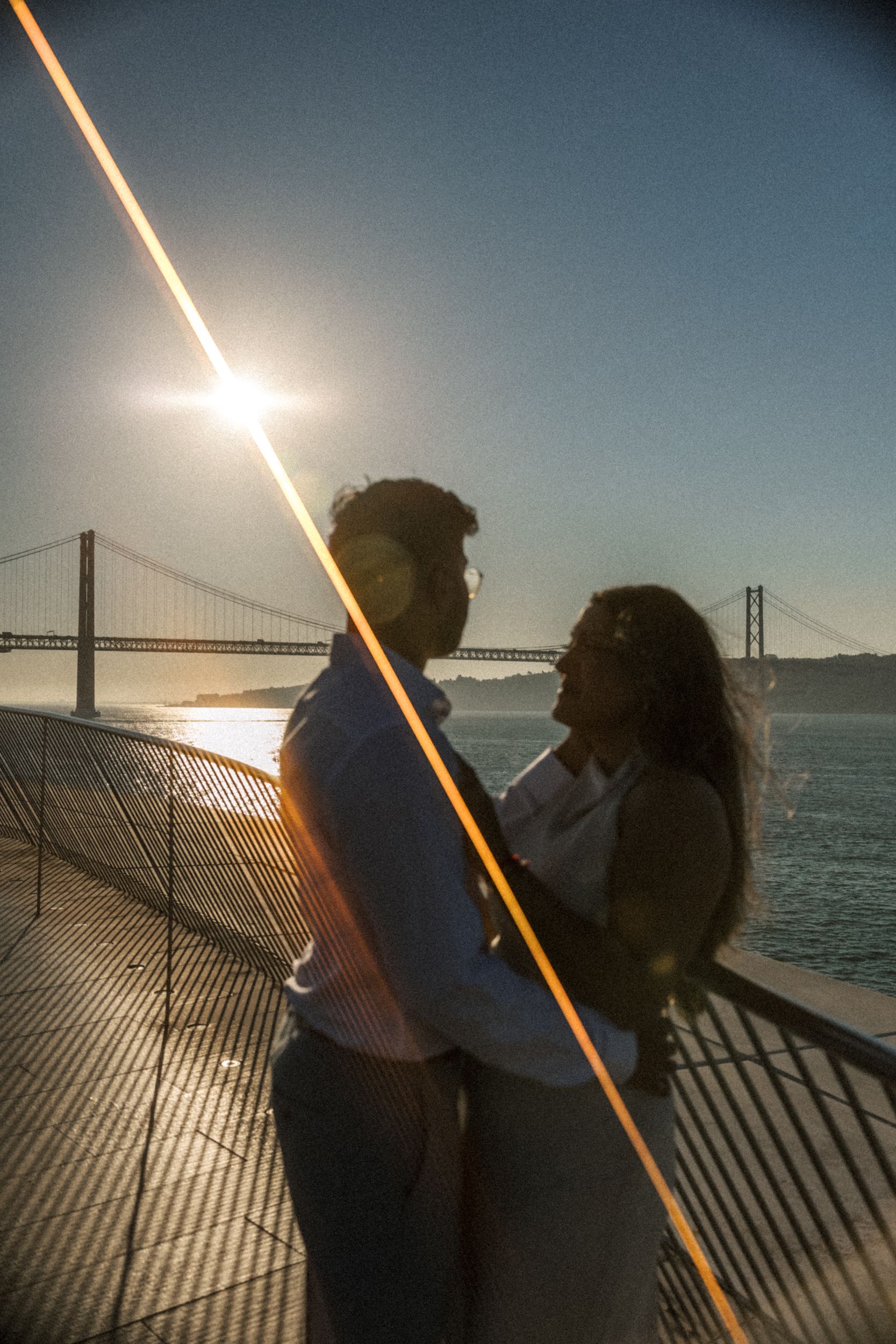 Destination couple session overlooking Lisbon bridge at sunset
