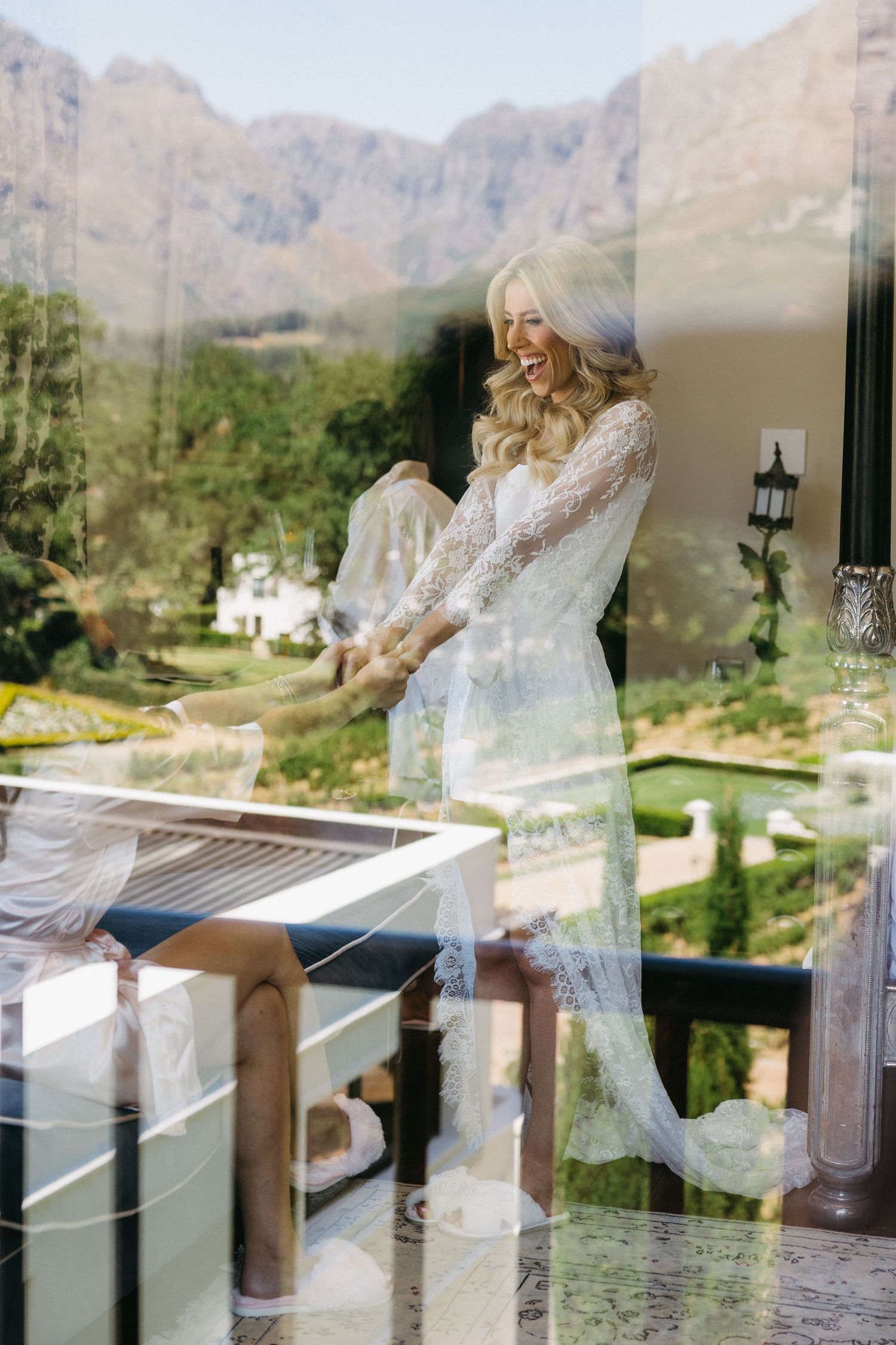A sequence of photos showing a person in white sitting on a balcony railing with mountains in the background.