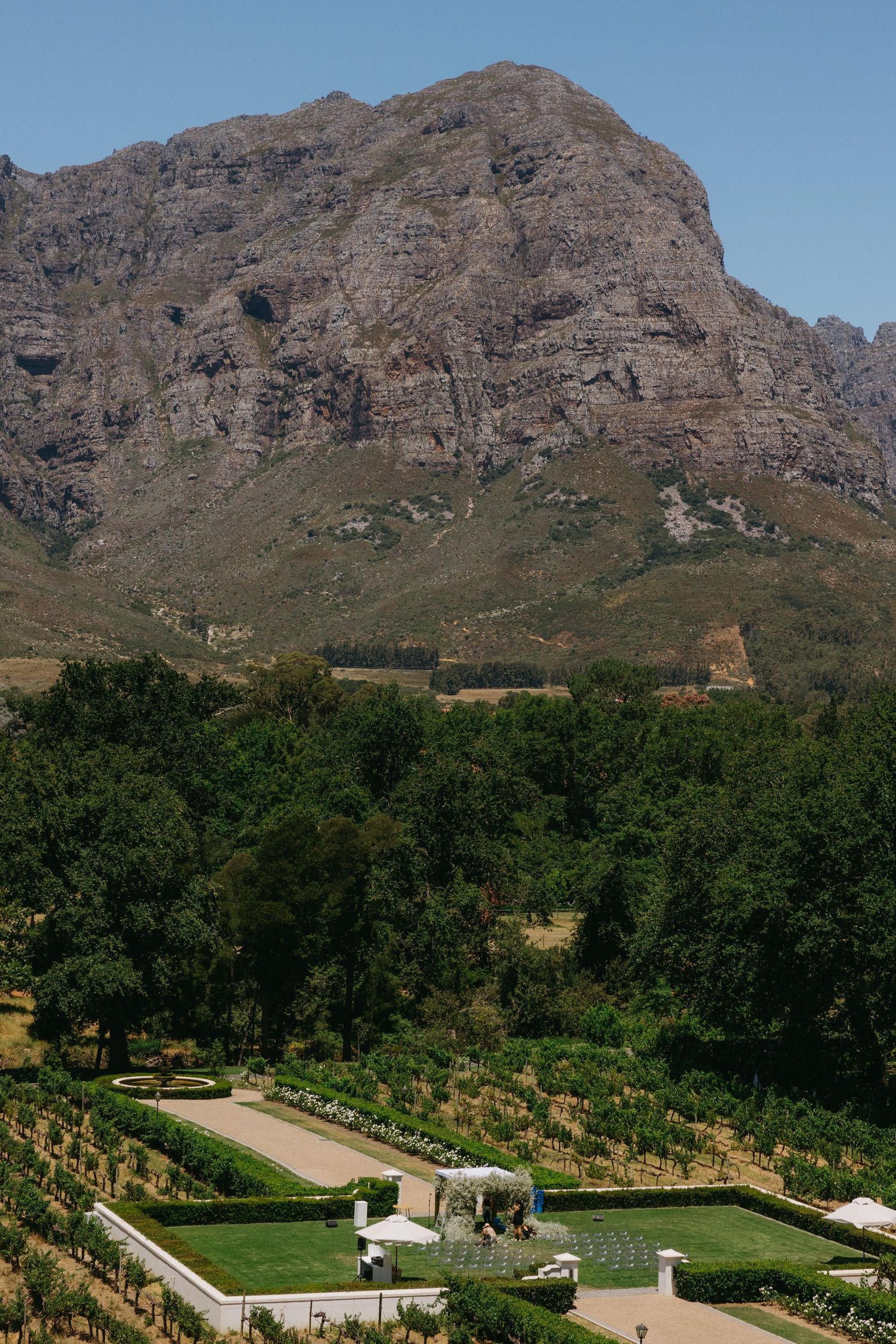 Manicured garden courtyard with mountain backdrop at Tokara Wine Estate in Stellenbosch, South Africa.