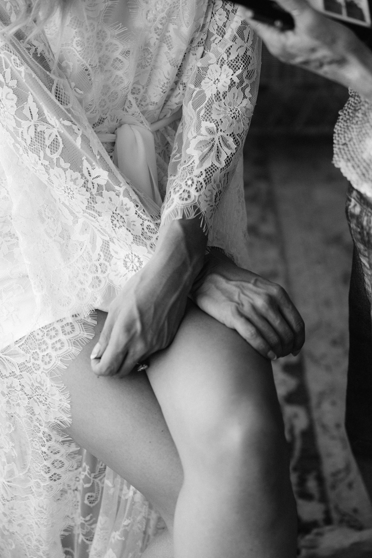 Delicate white lace fabric details shown in a series of close-up black and white photographs.