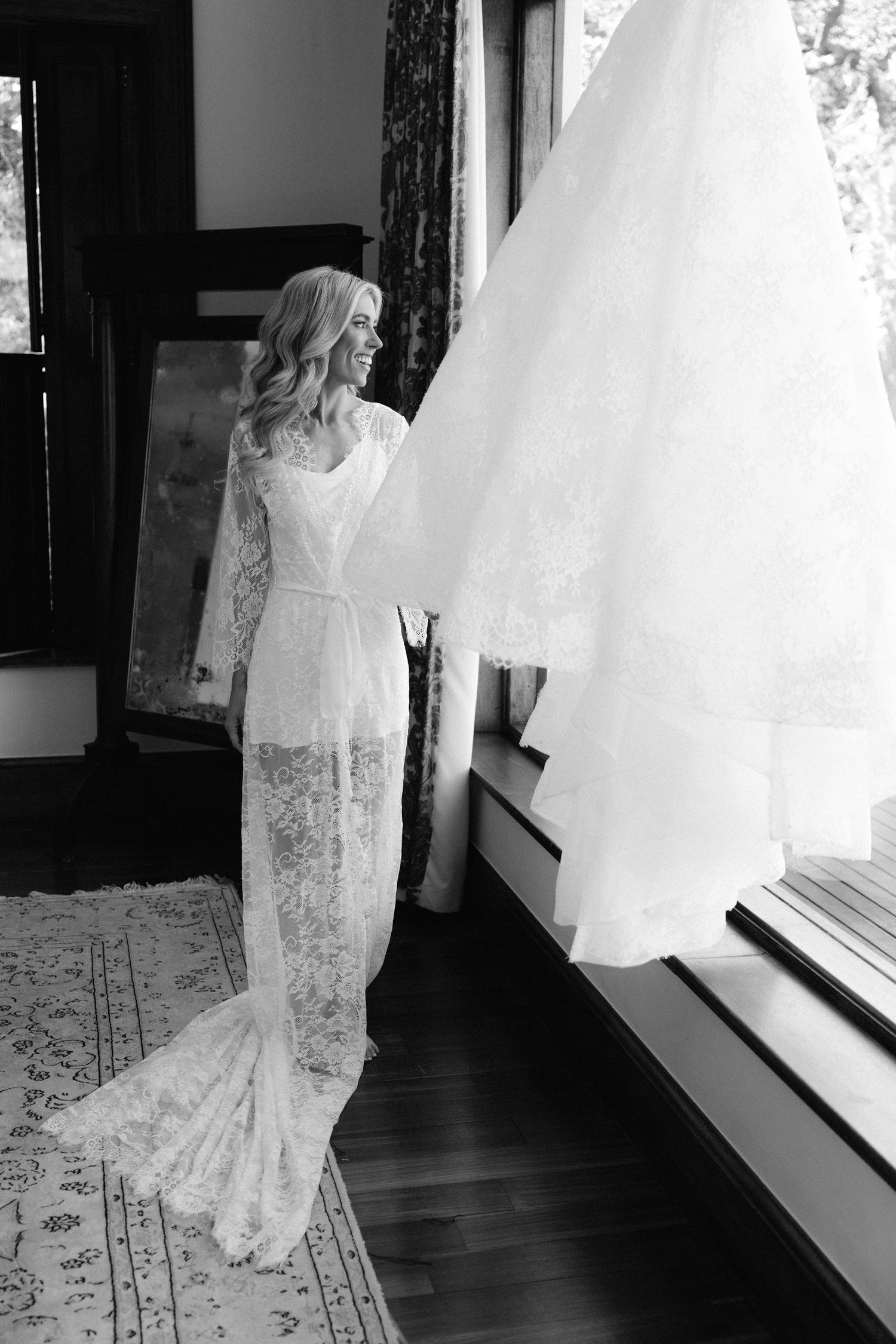 A person in a white lace wedding dress stands by a window in a series of black and white photographs.
