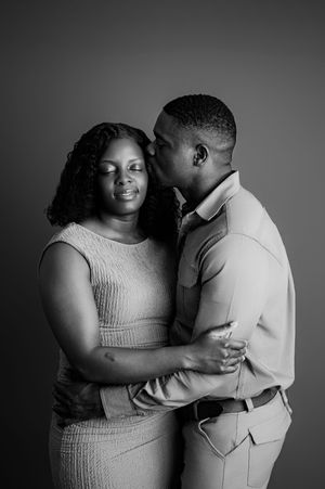 A tender black and white photo series captures intimate moments between a couple in romantic poses.