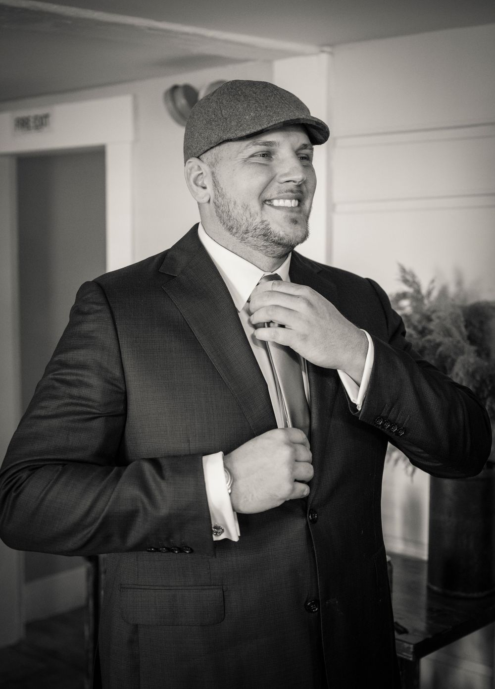 Black and white photos show groomsmen adjusting ties and sharing candid moments before ceremony.