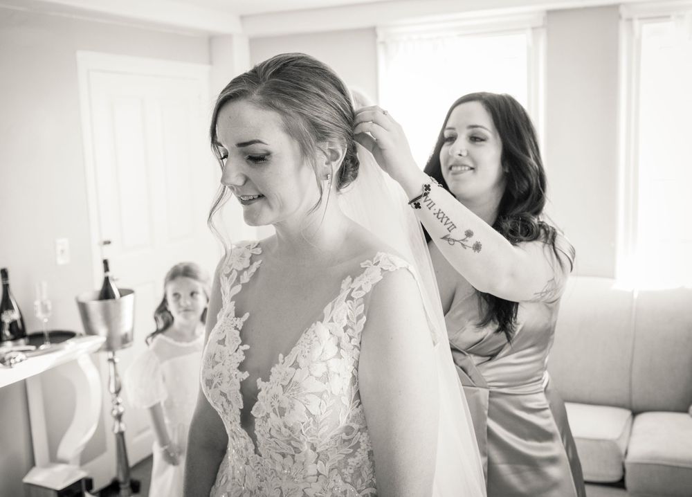 Black and white photo sequence showing wedding preparation moments in a bright room.