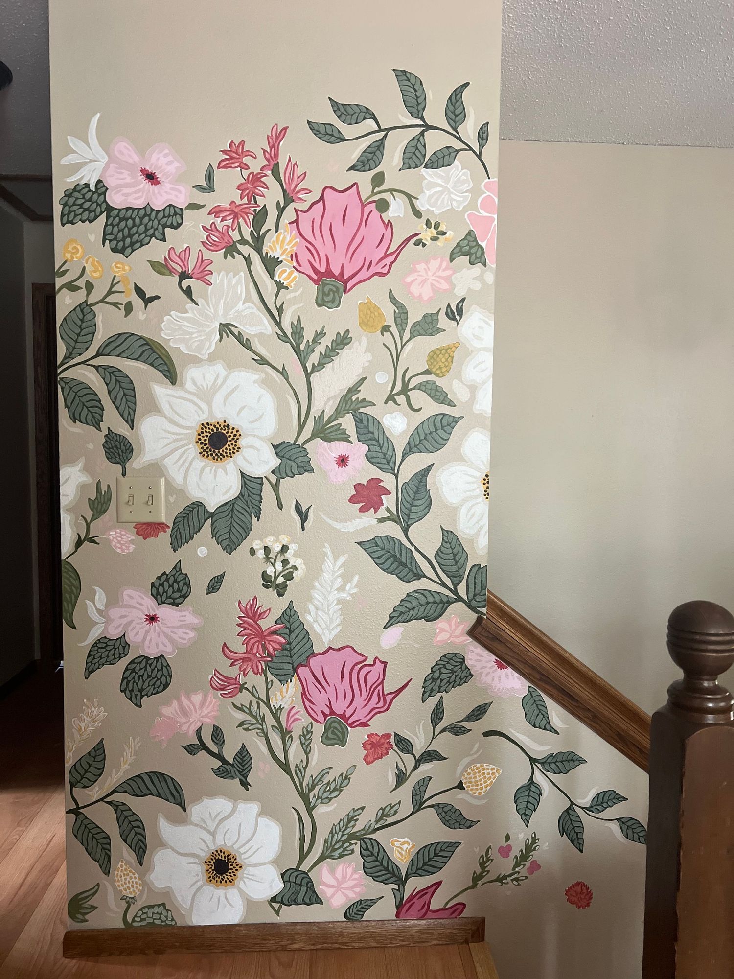 Floral wallpaper pattern featuring pink blooms, white flowers, and green leaves in a vintage botanical style.