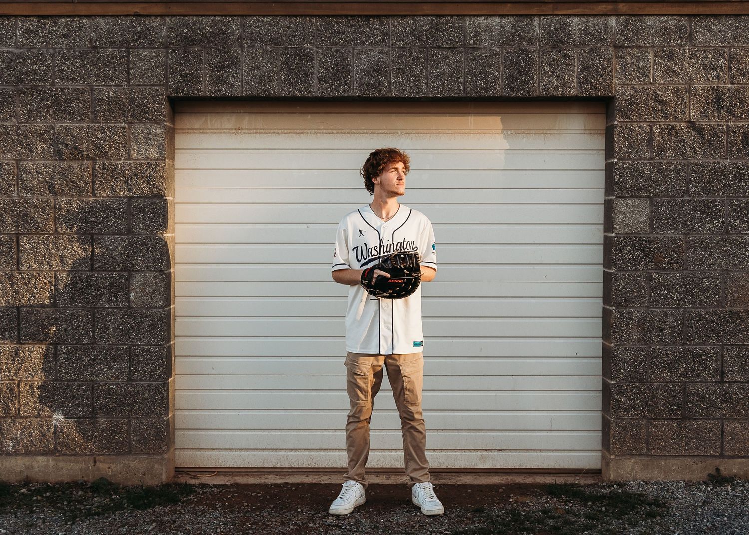 A series of five connected photos showing a person posing against a stone wall and white garage door background.