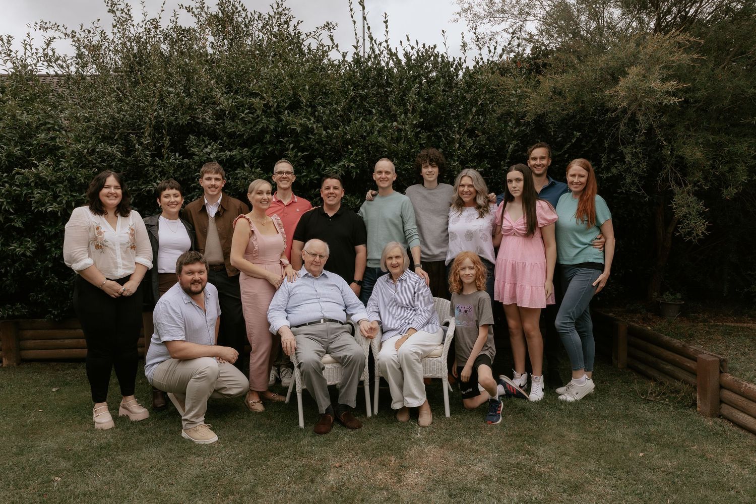 A series of outdoor group photos showing people sitting and standing together in a casual outdoor setting.