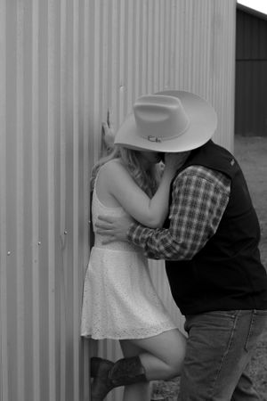 Romantic black and white photo sequence of couple embracing against industrial wall.