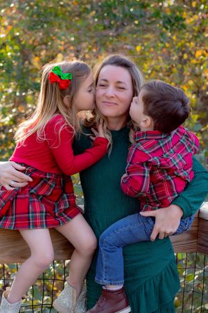 A series of sweet family moments captured outdoors showing affection and hugs against an autumn backdrop.