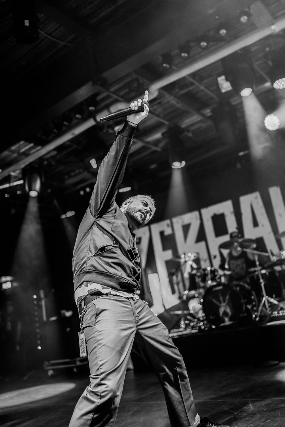 Dynamic black and white concert photos showing energetic stage performance with dramatic lighting and movement.