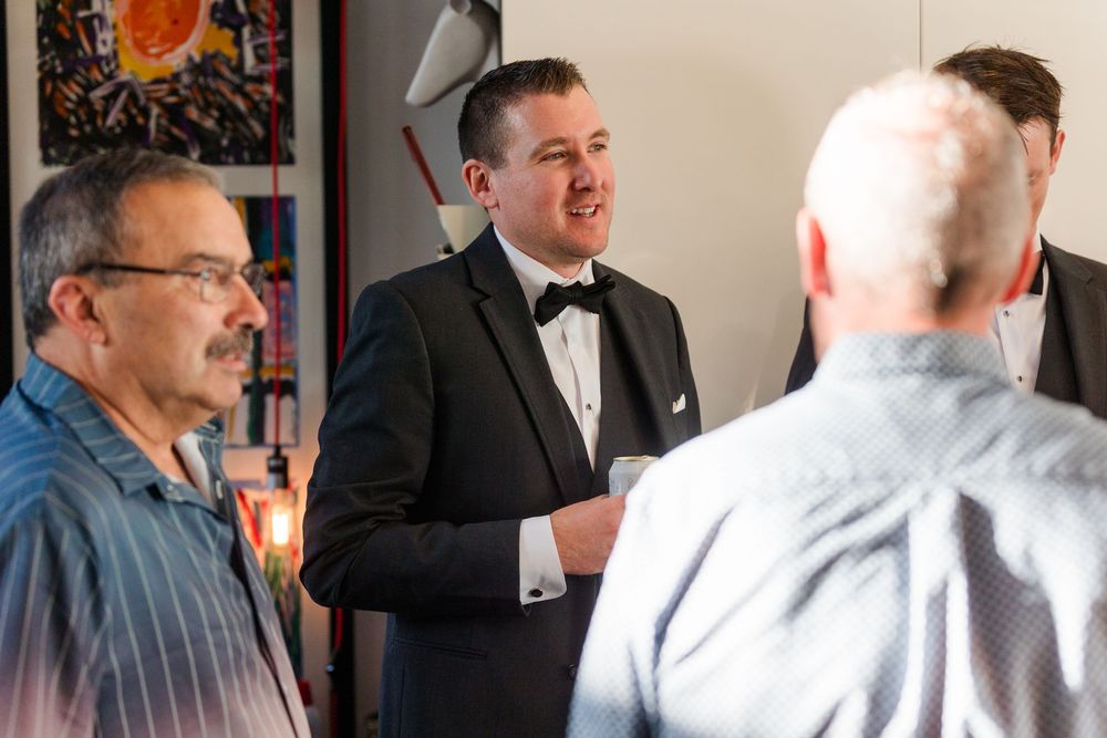 A group of people in formal attire engage in conversation at a business networking event.