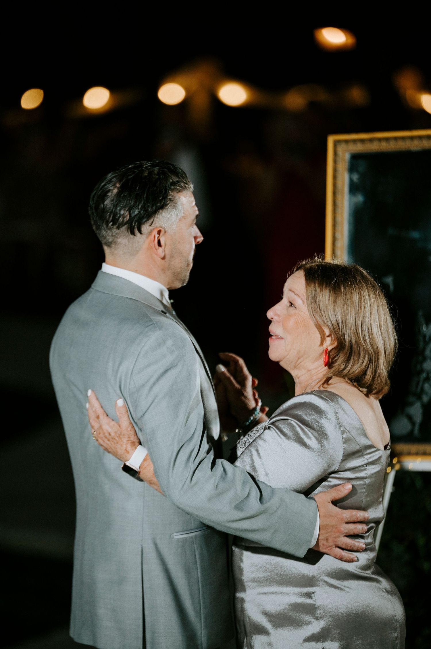 Couple dancing together in formal attire at an evening reception.