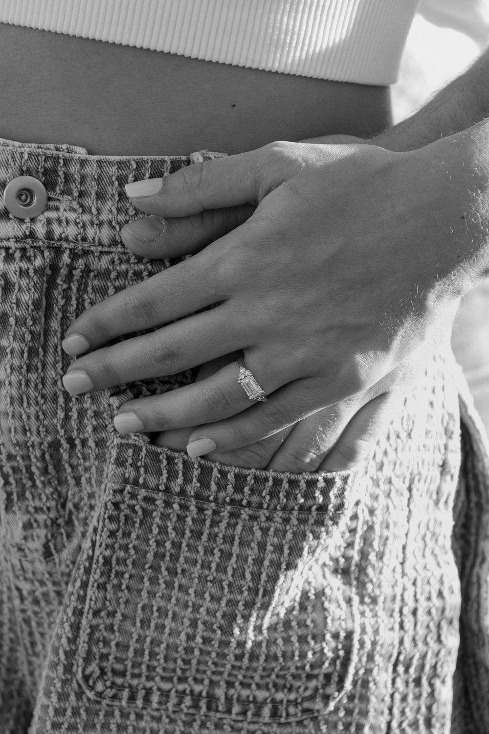 A hand smooths bubble wrap packaging material across a textured surface in a sequence of black and white photos.