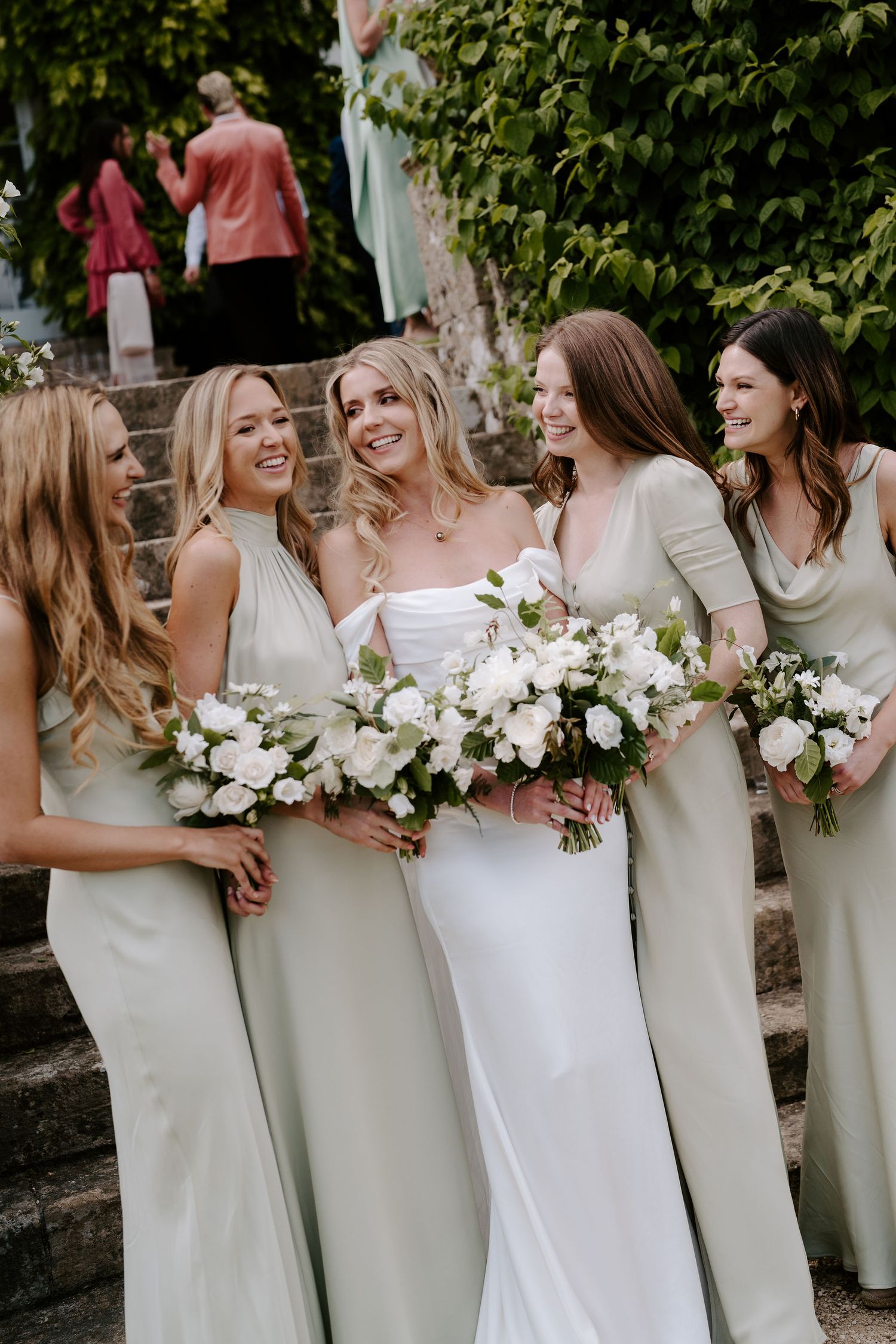 bride and bridesmaids laughing with each other at hamswell house wedding bath