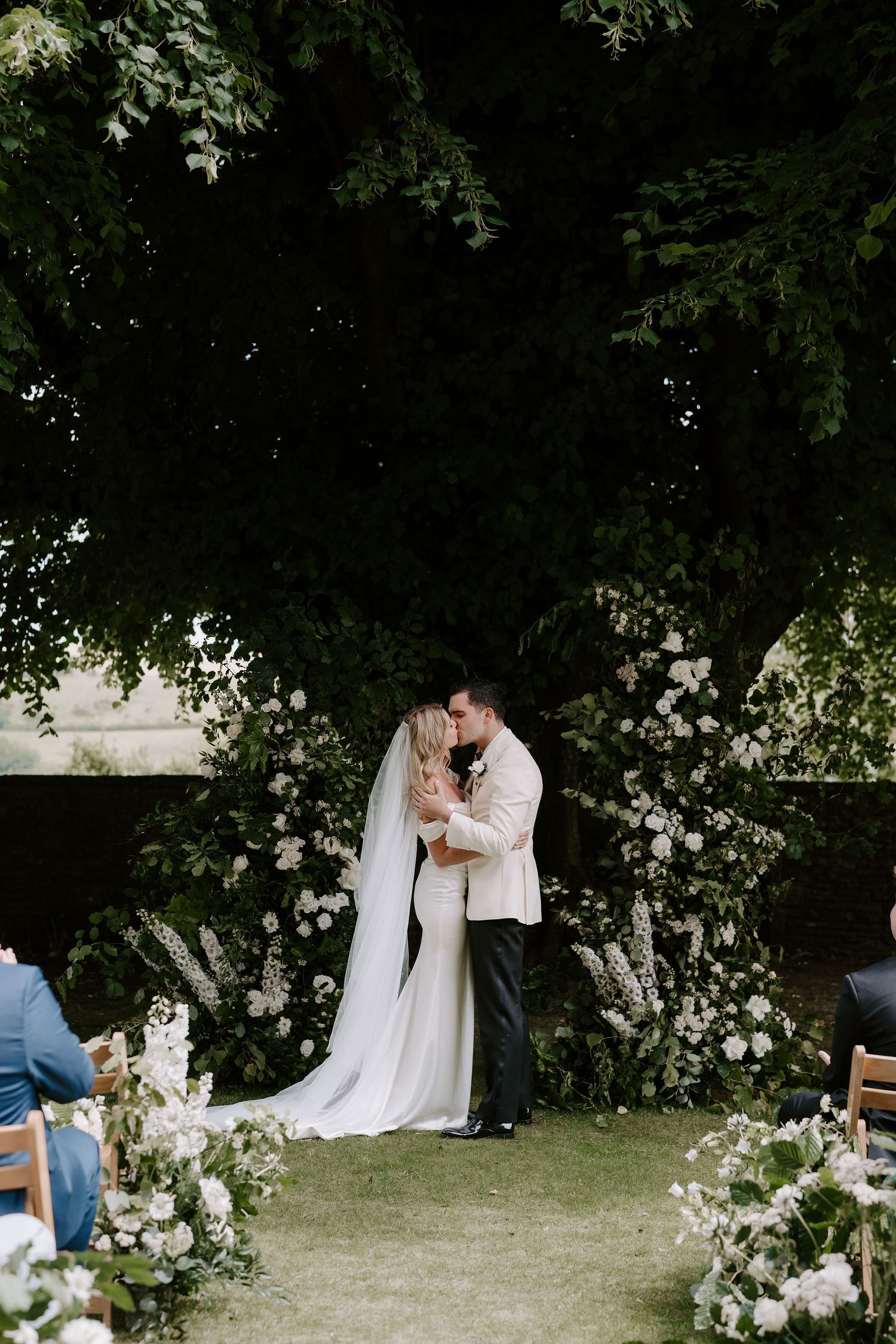 bride and groom sharing first kiss during ceremony at Hamswell house in bath
