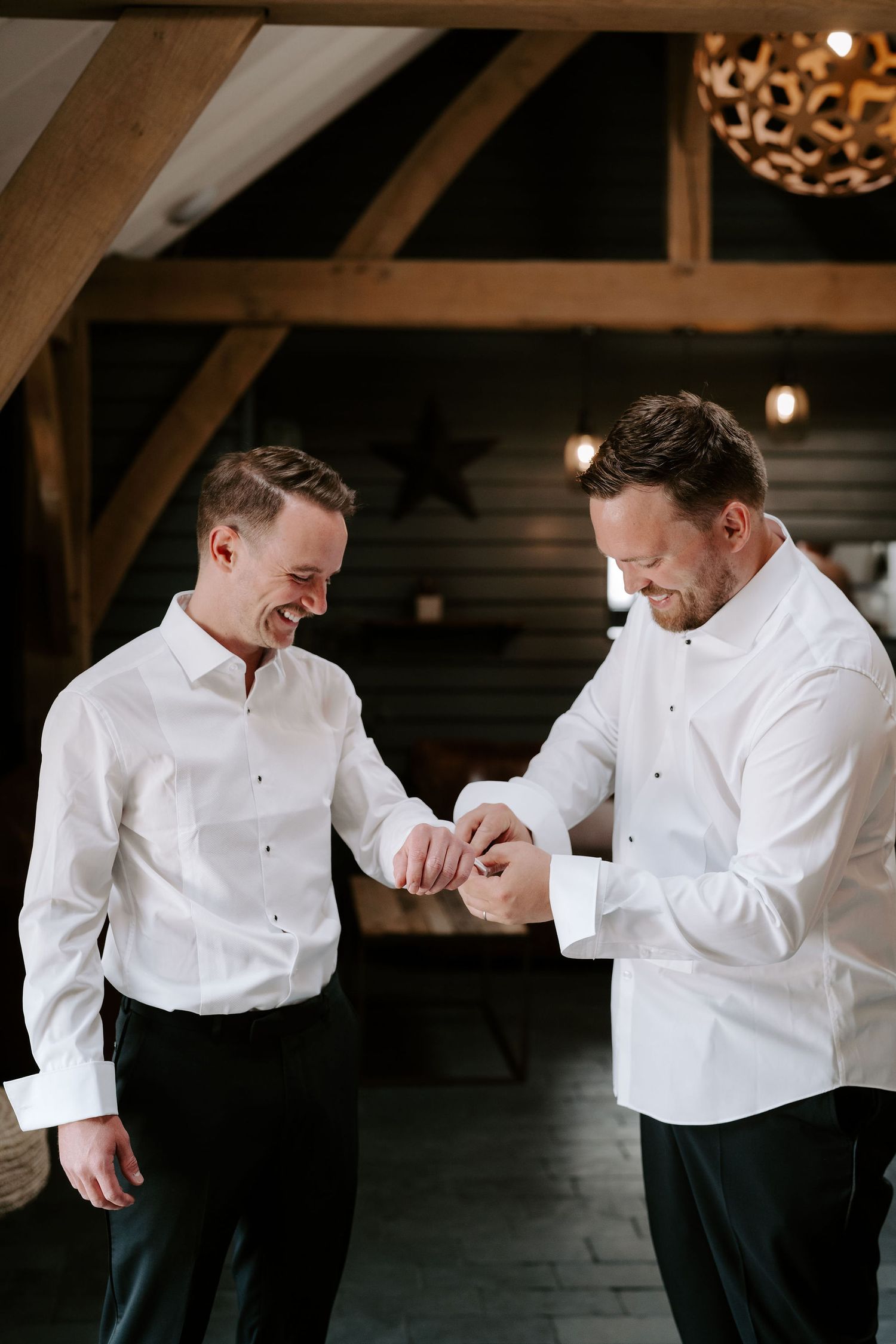 Tunnels Beach Wedding Venue in North Devon, best man helping groom with cufflinks
