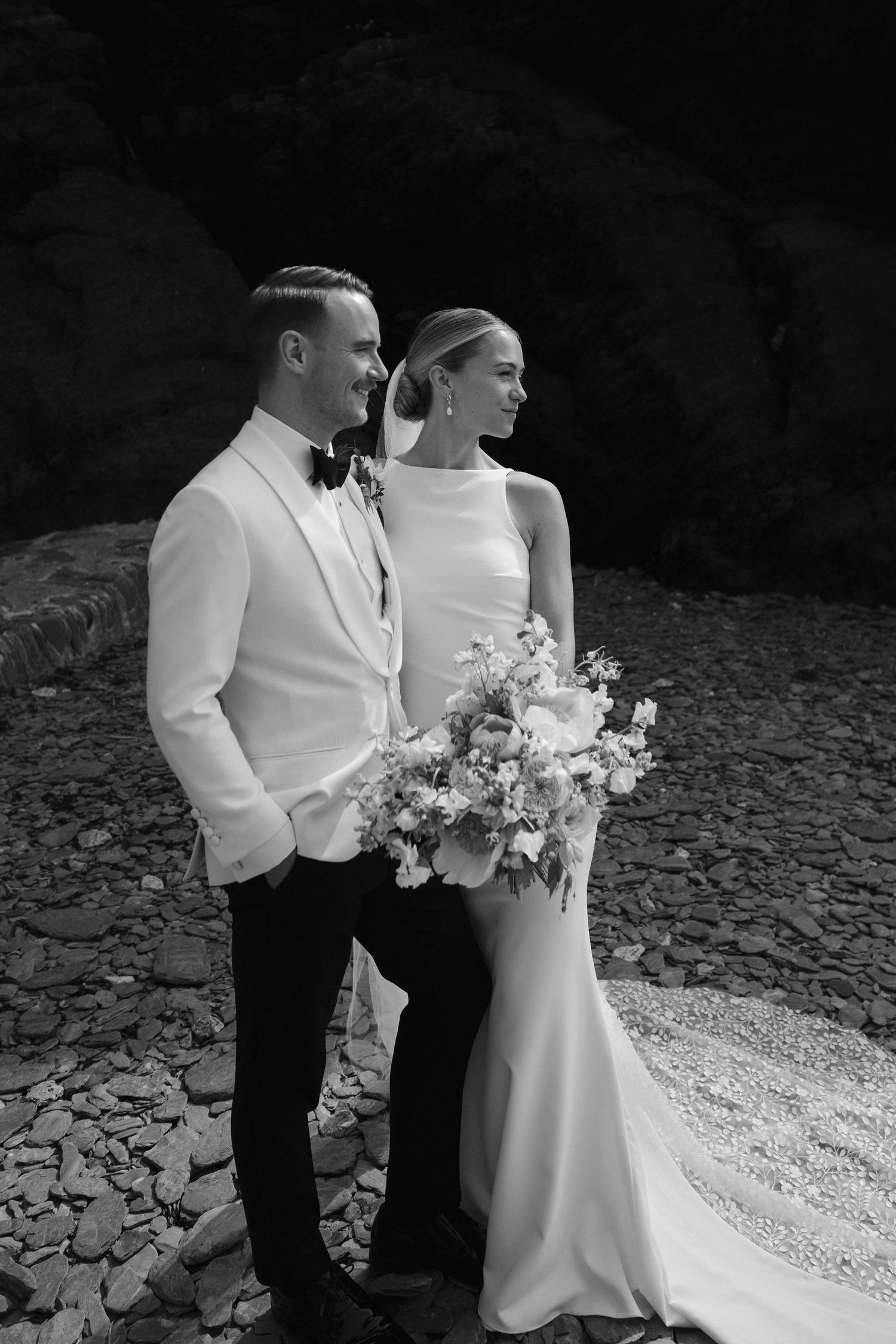 Bride and Groom relaxing on beach at Tunnels beach wedding venue in north devon