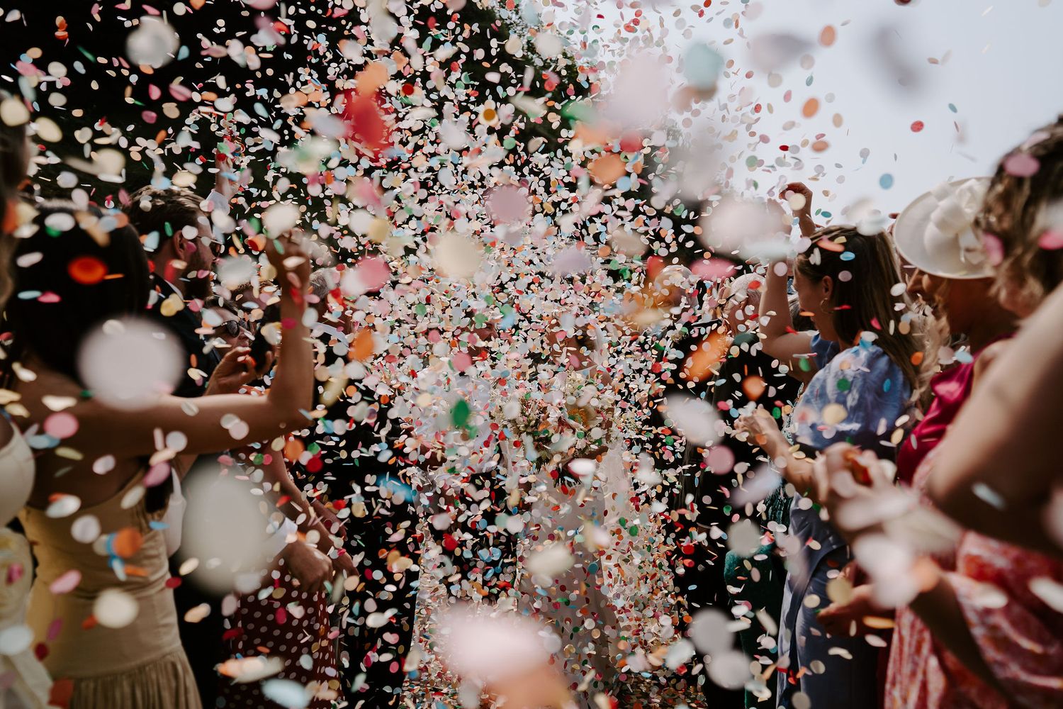 Bride and groom confetti throw at tunnels beach wedding venue in north Devon