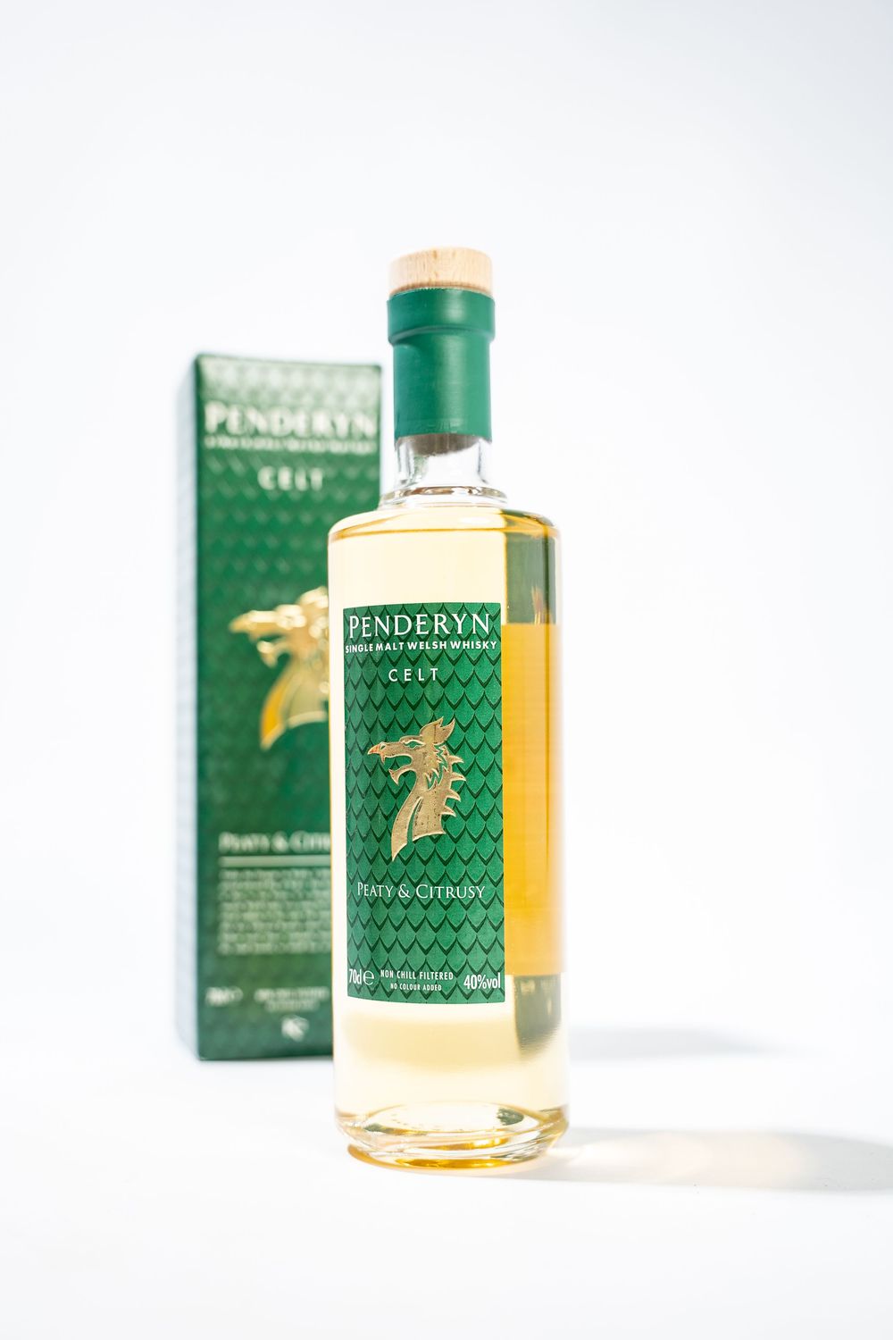 A bottle of Penderyn Welsh whisky with green packaging displayed against a white background.