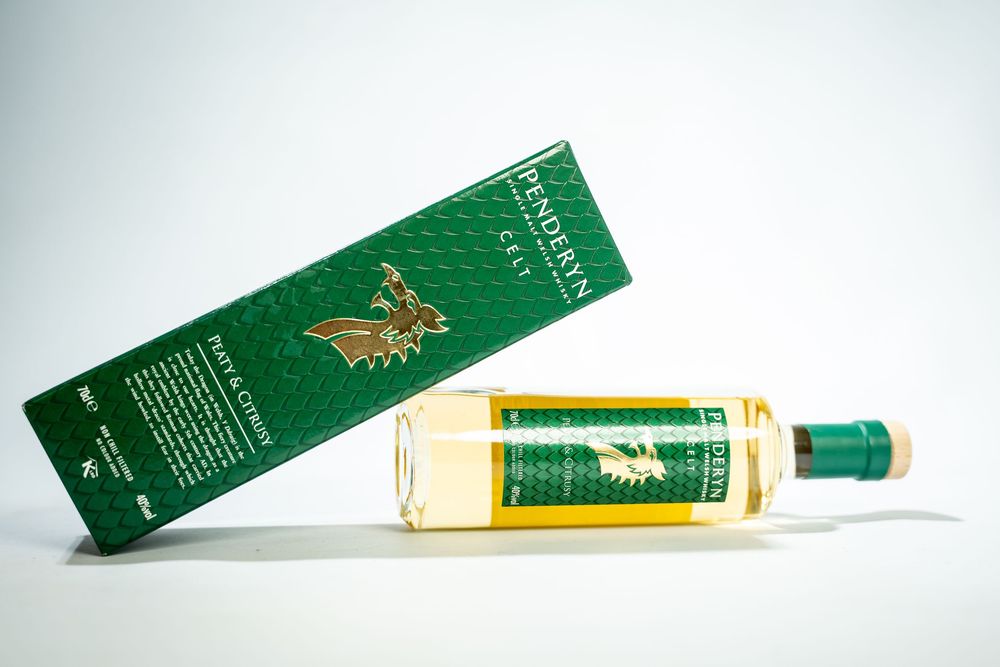 Green and gold luxury fragrance boxes arranged in a minimalist composition on white background.