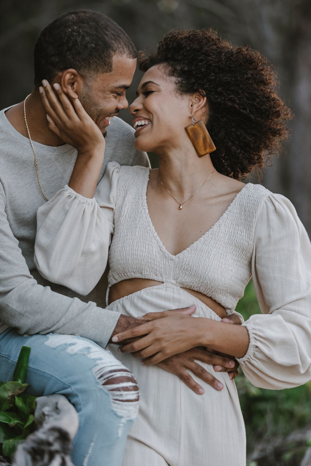 Intimate outdoor couple portrait showing tender romantic moment.