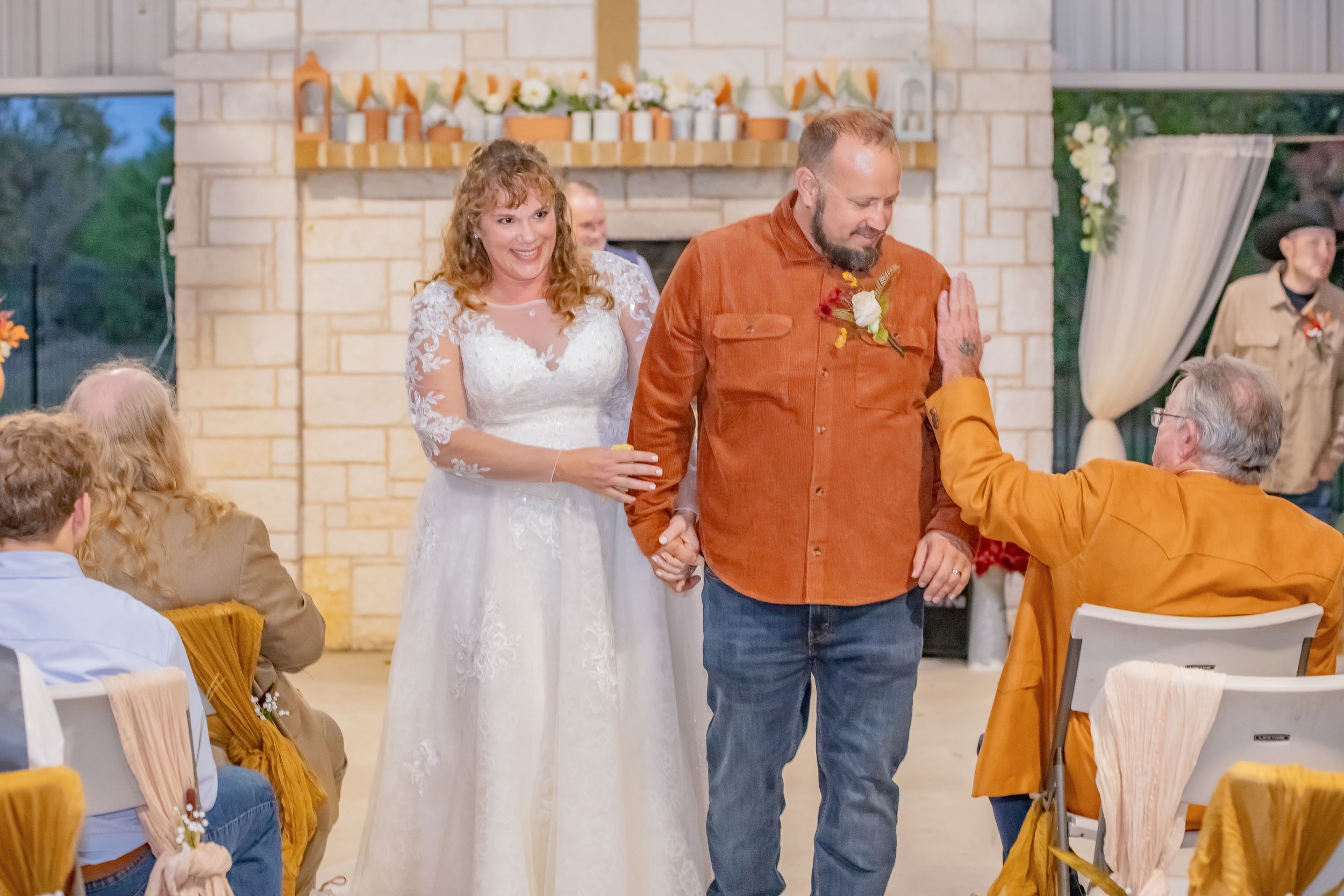 Wedding reception sequence showing couple dancing in rustic venue with stone walls and warm lighting.
