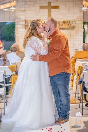 Wedding dance photos with bride in white gown and partner in brown jacket at indoor venue.