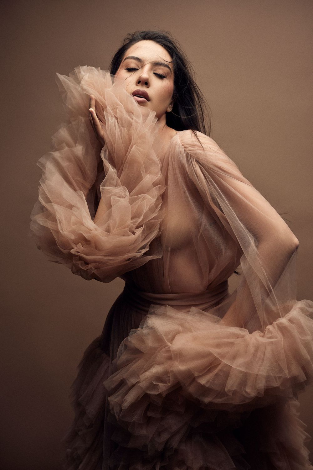 Ethereal fashion photos with flowing peach tulle fabric creating dynamic movement.