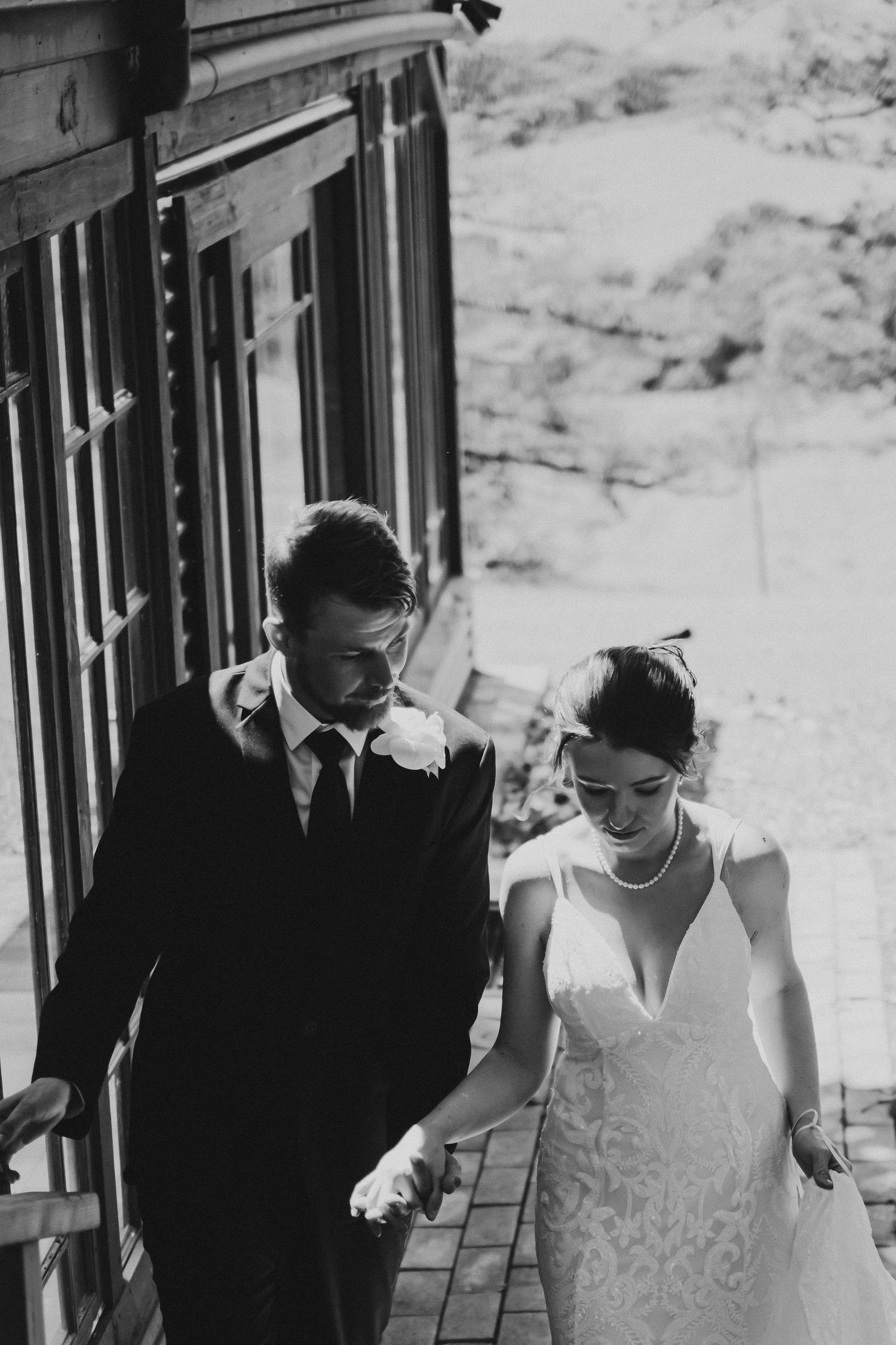 Black and white wedding photo on a vintage train platform.