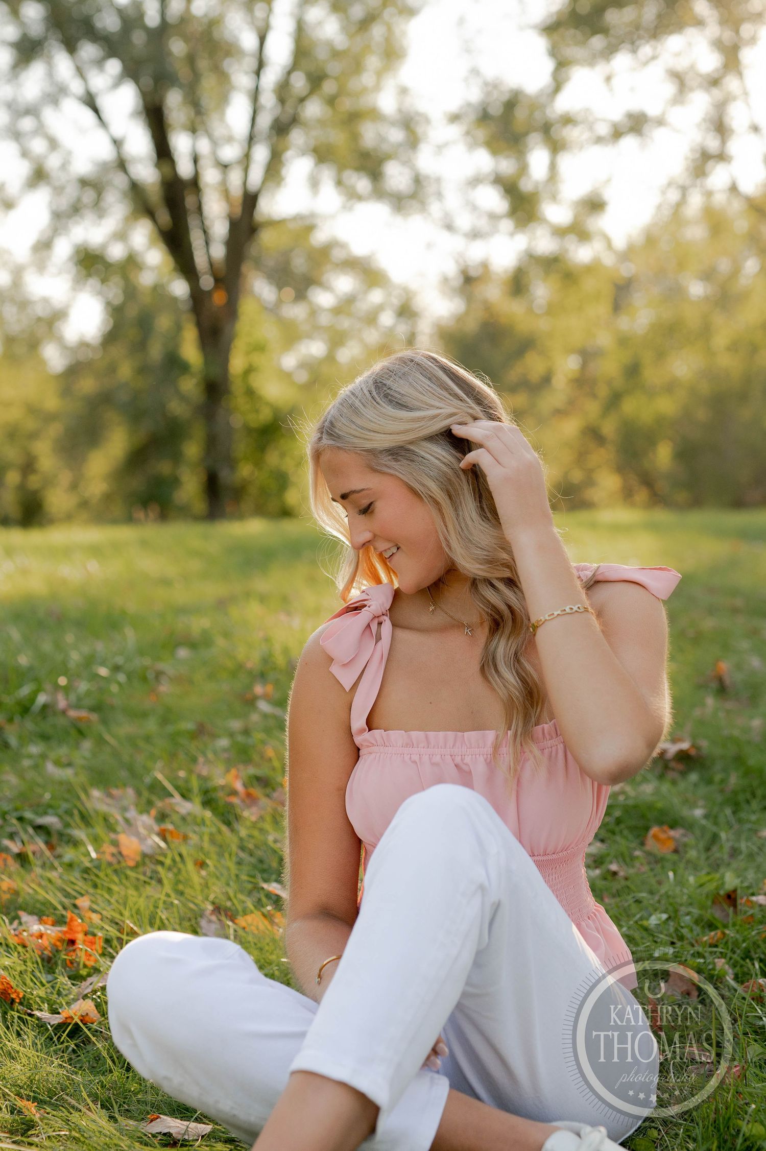 Intimate outdoor portrait with soft lighting and natural pose on grass.