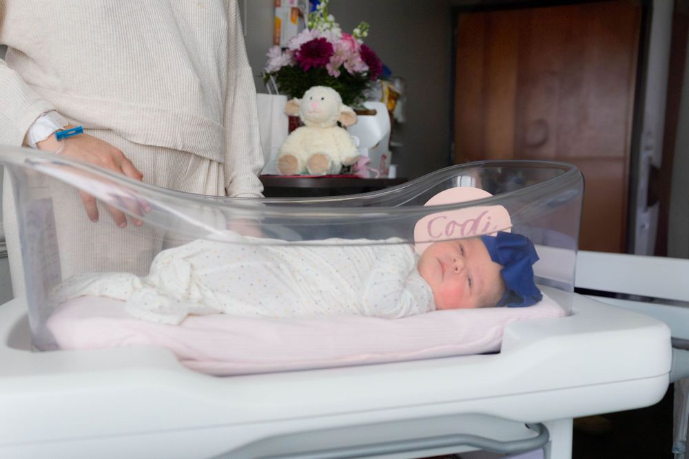 Newborn wrapped in hospital blanket during Fresh 48 session in Beaumont, TX
