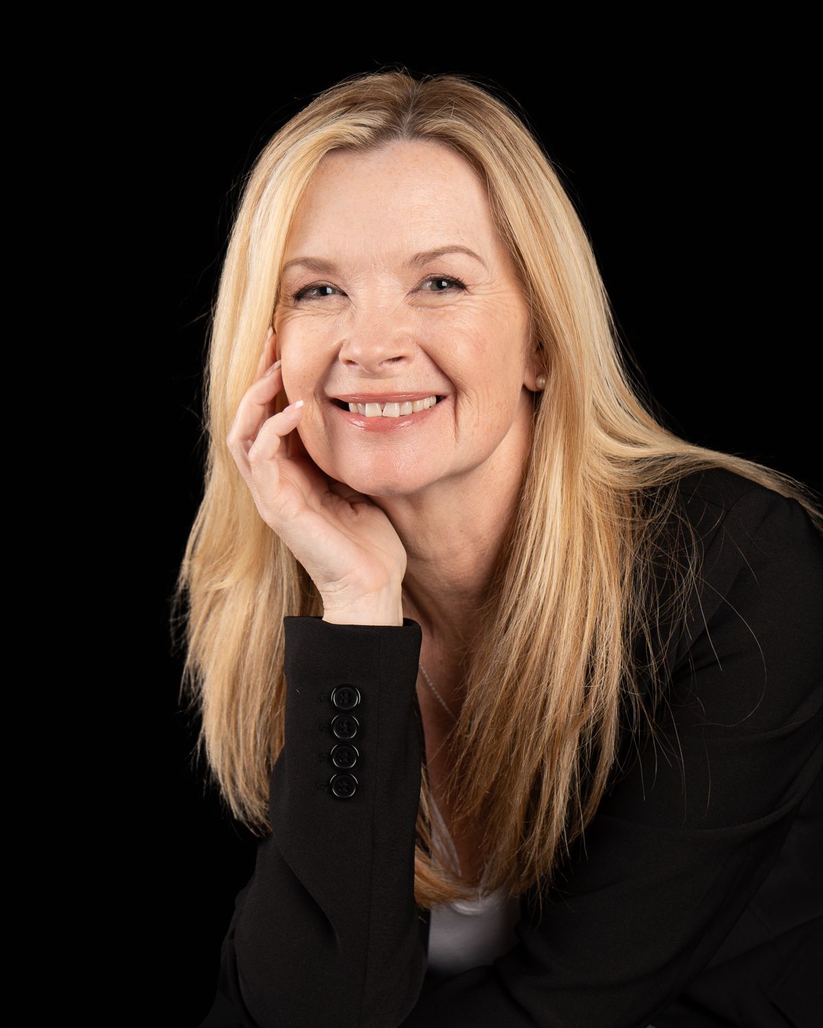 Professional headshots against black background showing warm expressions and blonde hair.