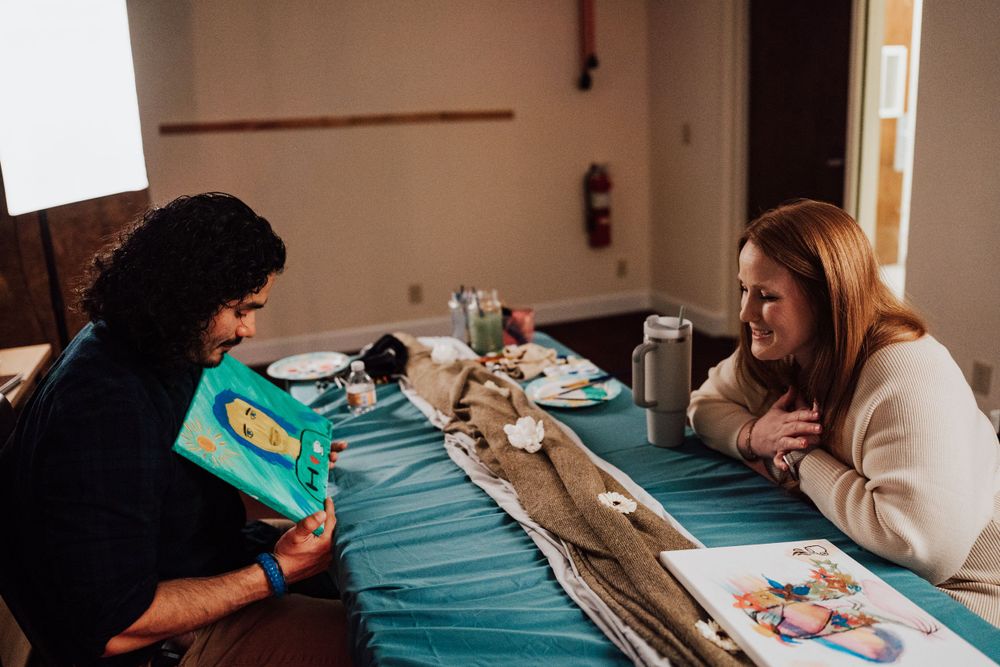Engaged couple reveal their portrait paints at Sip & paint date night at Nicolle Aponte Photography Studio in Middletown, PA