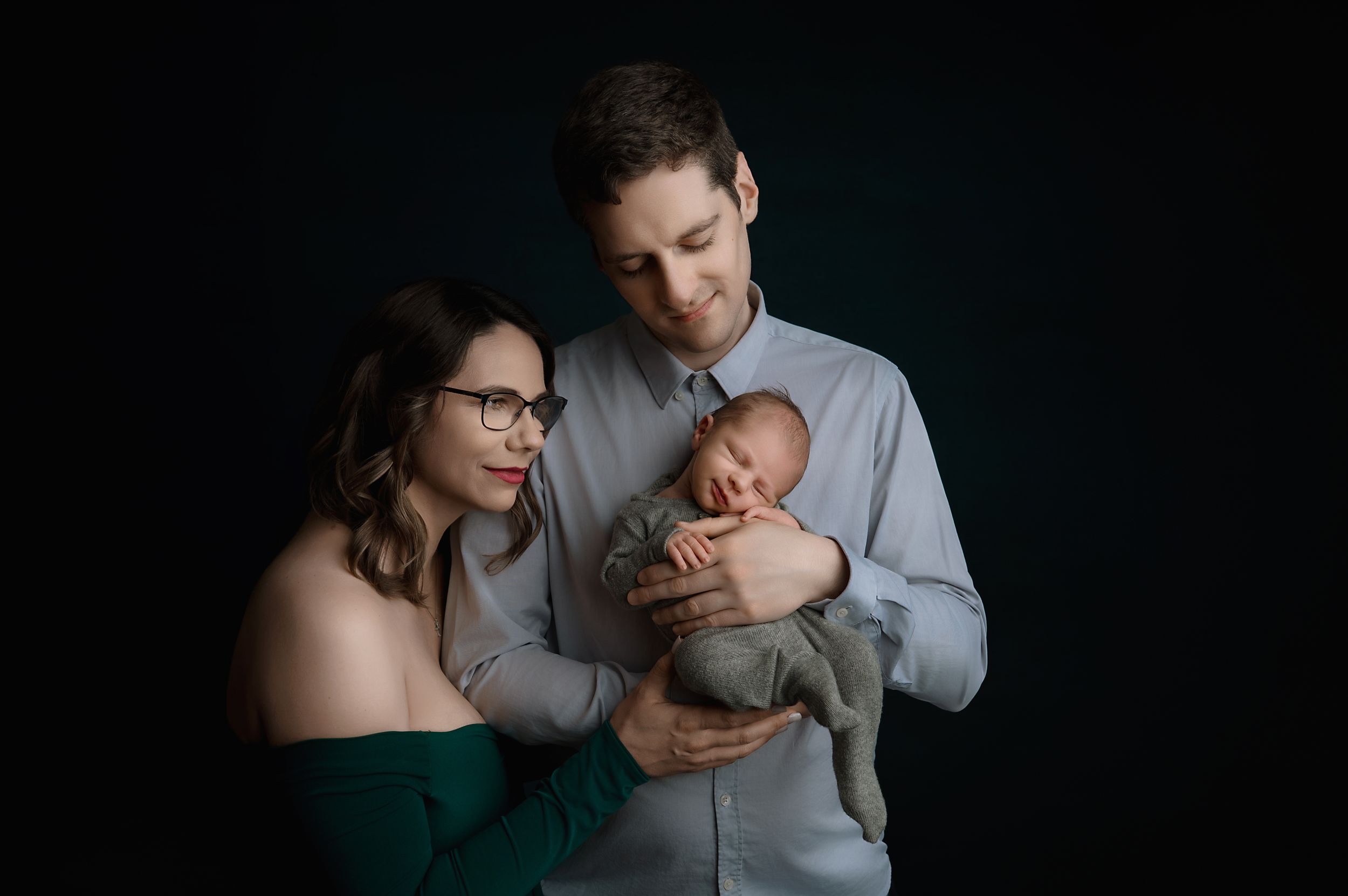 A series of black and white intimate photography shots showing tender moments between a parent and newborn baby.