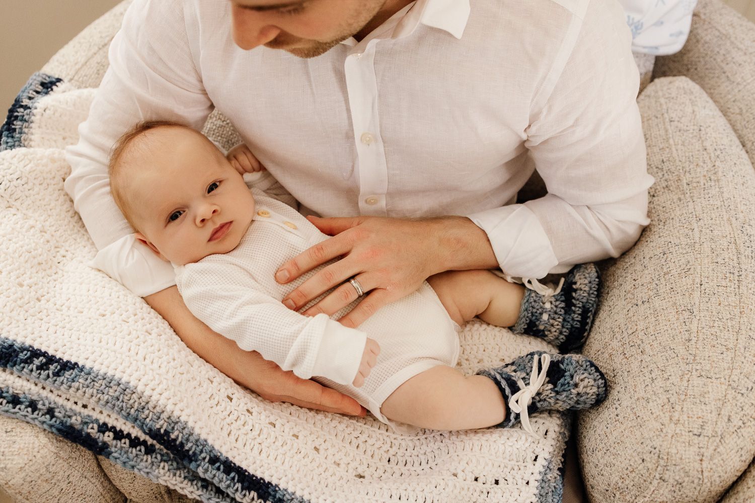 Hand-knitted blanket and booties are included in this baby photo with Bay Area newborn photographer Cindy Tucey in Los Altos Hills