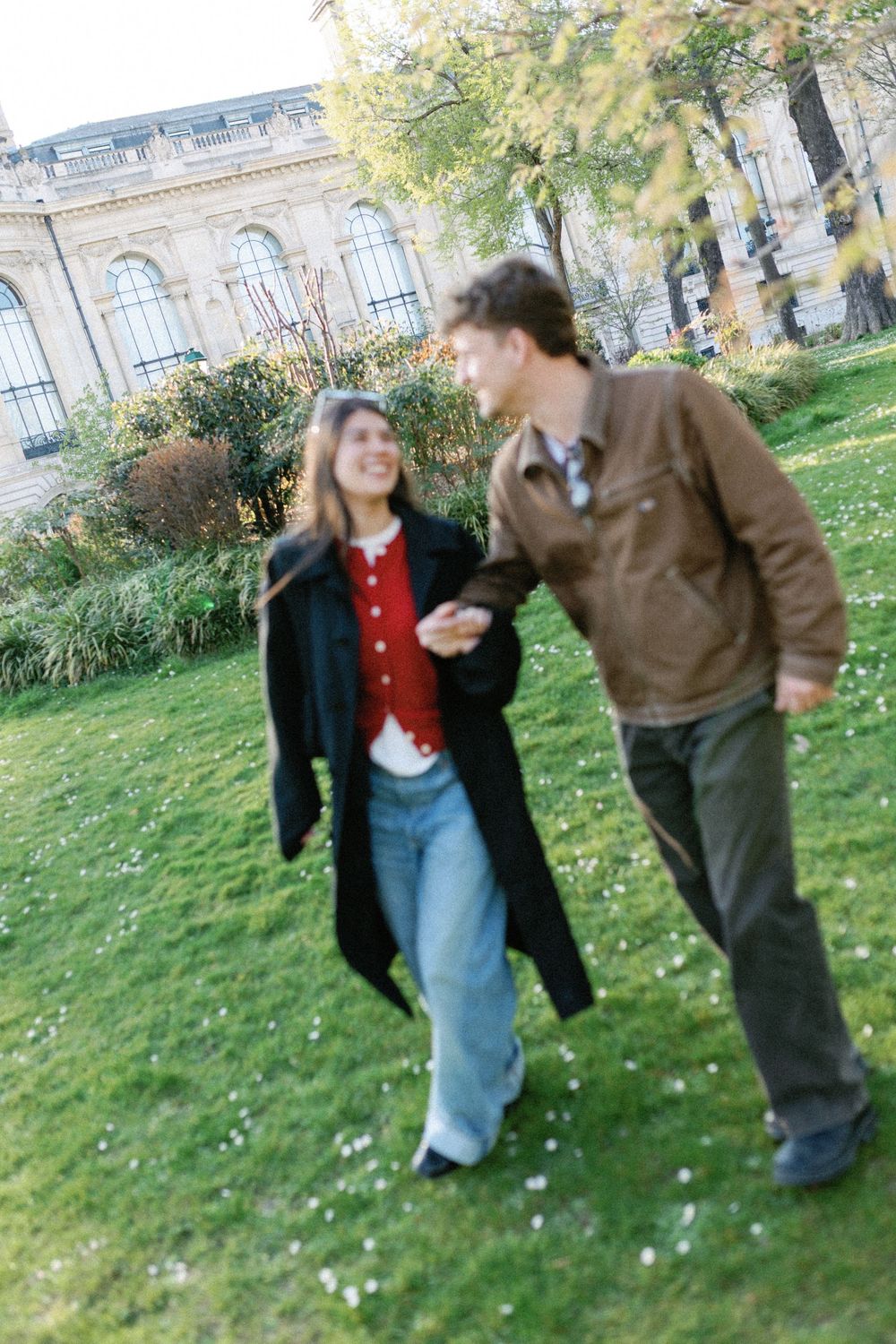 Five sequential photos show two people sharing a playful moment on a grassy lawn with a building visible in the background.