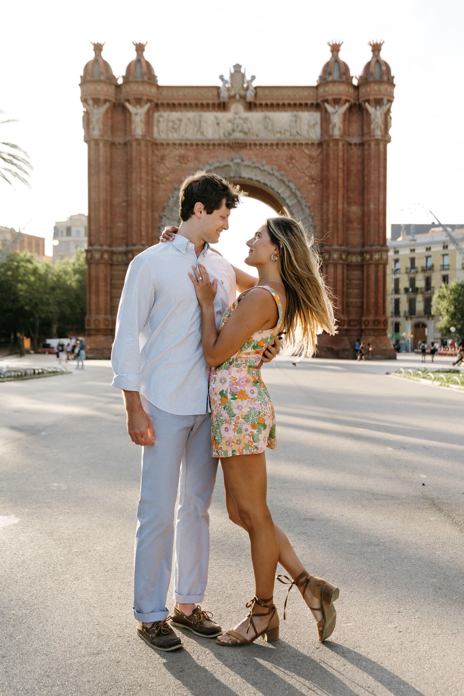 Playful dance moves captured in front of historic architectural landmark.
