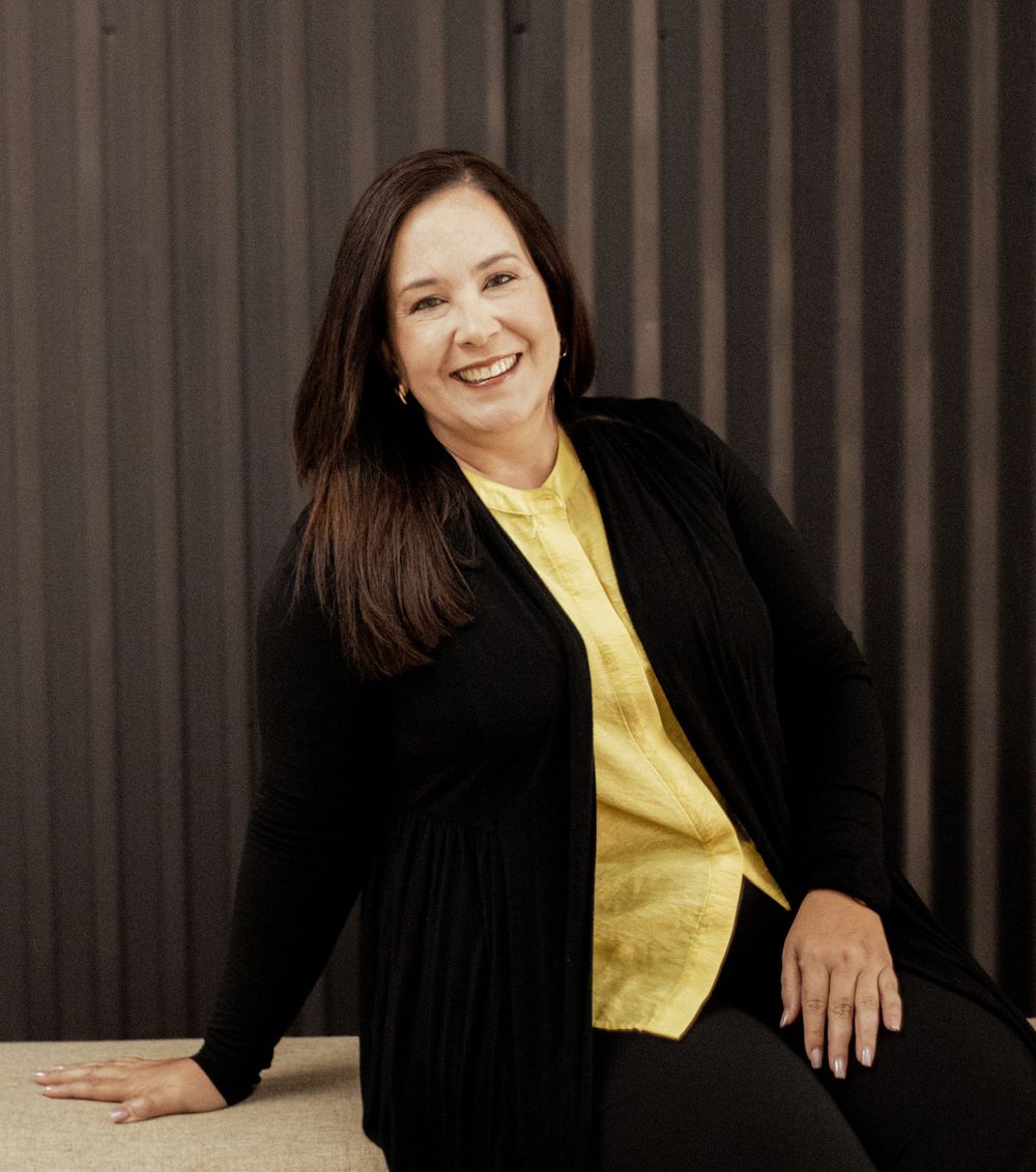 Four profile photos show someone in a black blazer over a yellow shirt against a dark striped background.