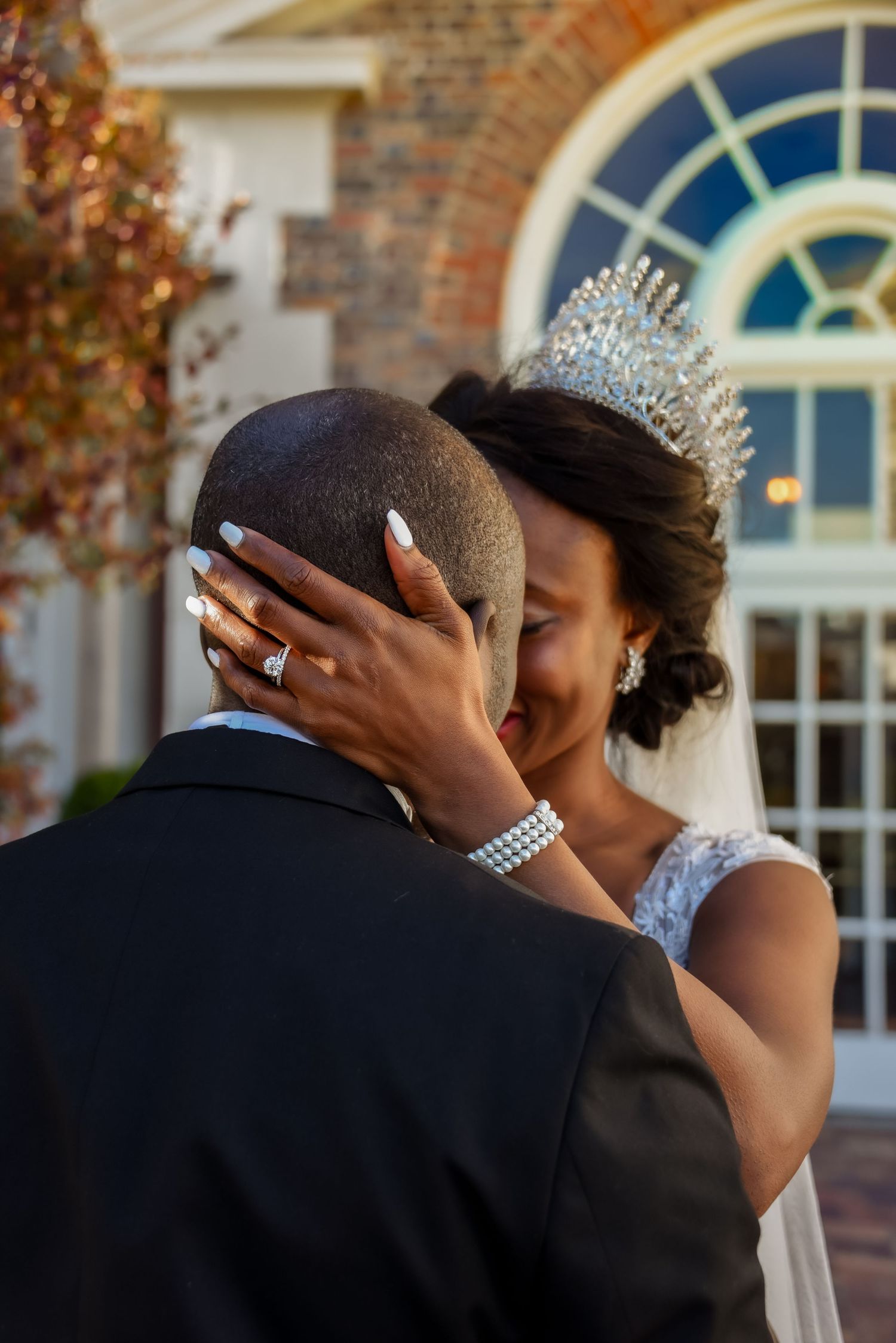 Close-up of bride and groom with ring showing