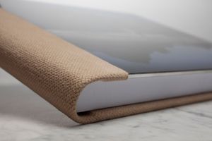 Side view of corrugated paper product being folded into shape showing various stages of assembly process.