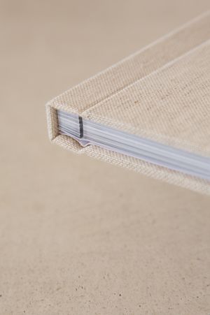 A sequence of close-up photos showing fine fiberglass strands being gently pulled away from a textured beige surface.