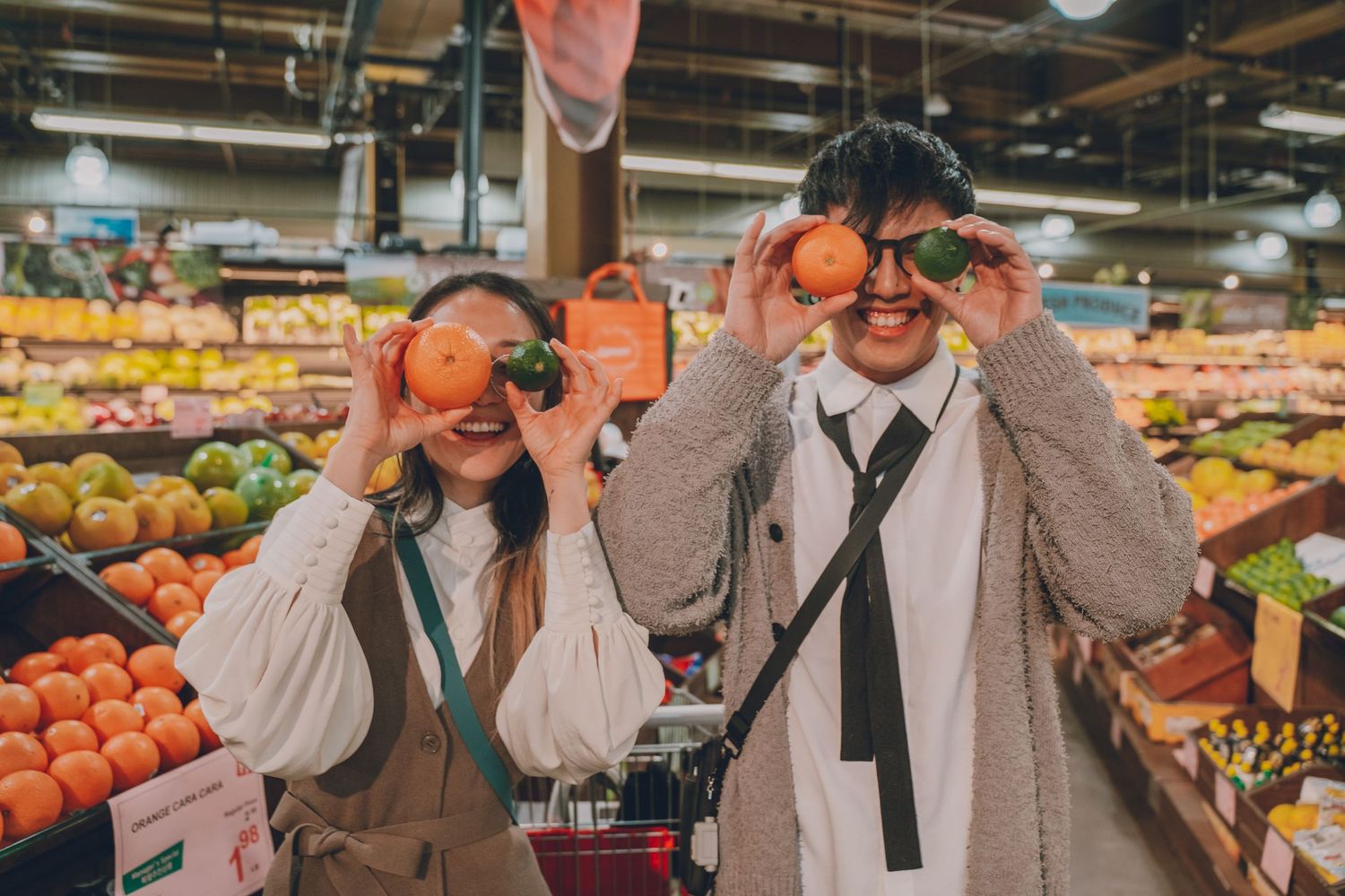 a cute couple holding up produce for silly images