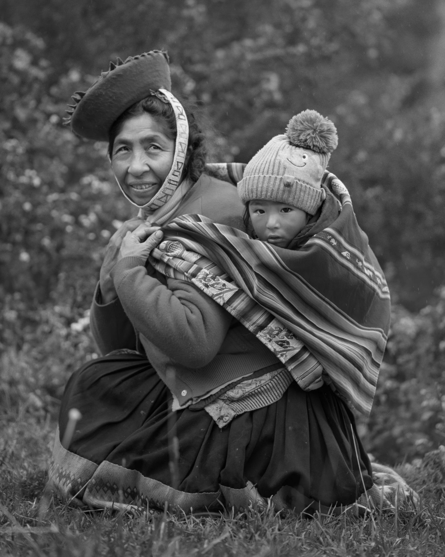 Black and white portrait showing traditional Andean dress with distinctive hat and woven shawl.
