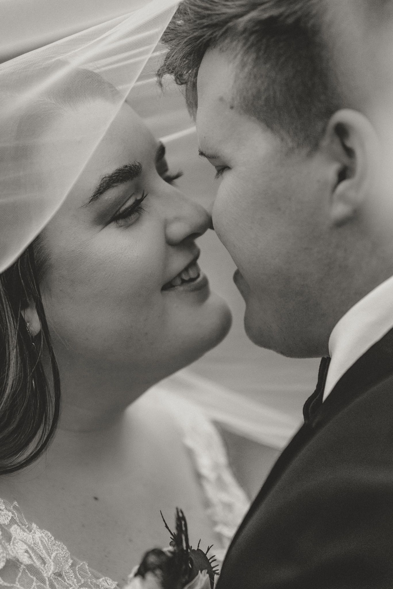 Close-up series of a tender wedding moment in black and white showing romantic interaction.
