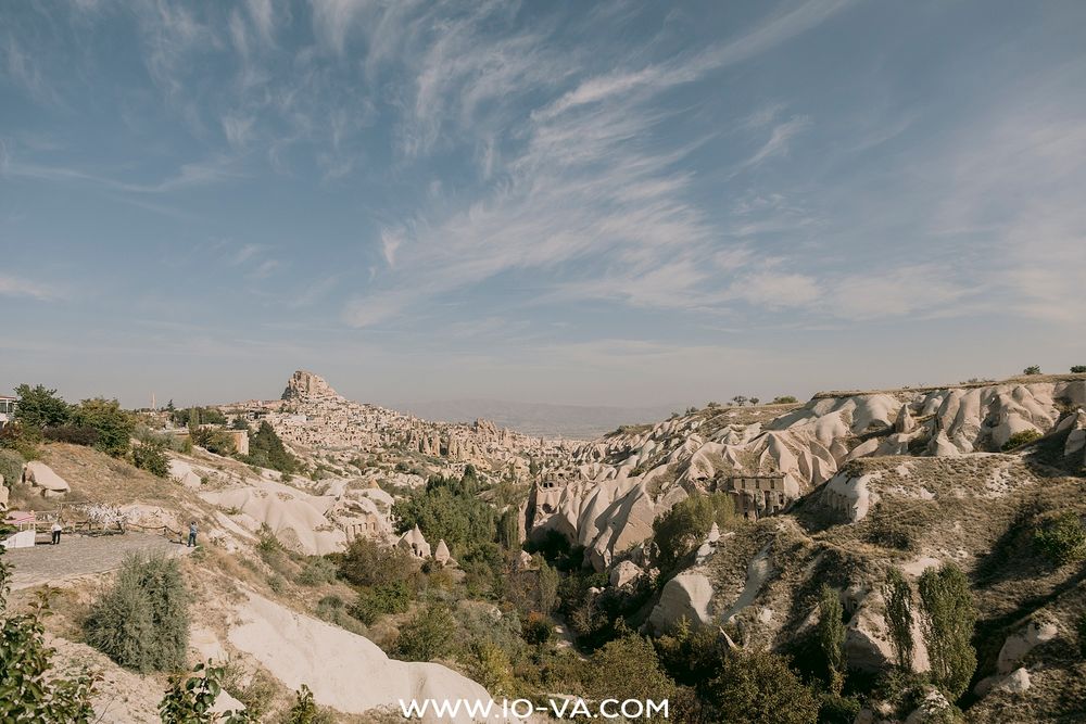 Panoramic view of Cappadocia's unique fairy chimney rock formations and Uchisar Castle in Turkey.