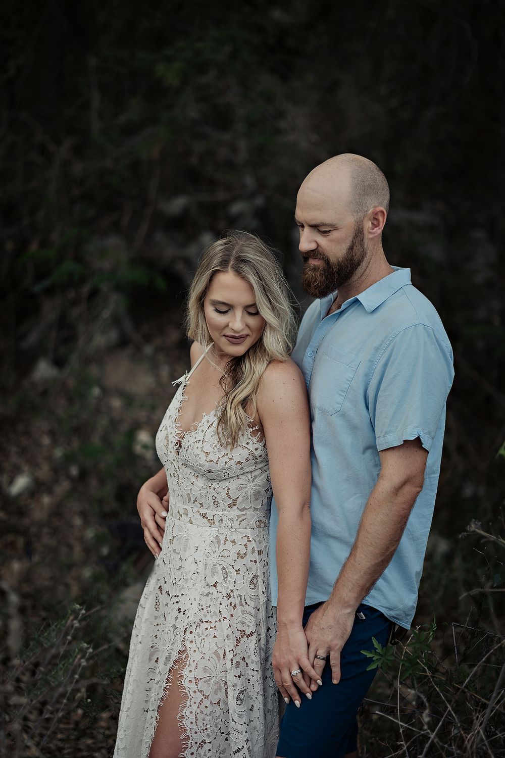 Lauren and Joshua standing closely in the jungle, holding hands and sharing a tender moment in Playa del Carmen.