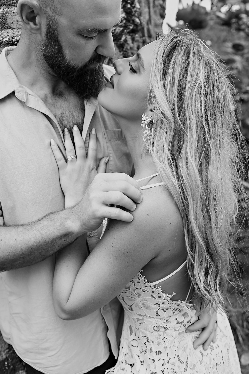 A romantic black and white photo series shows four intimate moments between a couple sharing tender kisses.