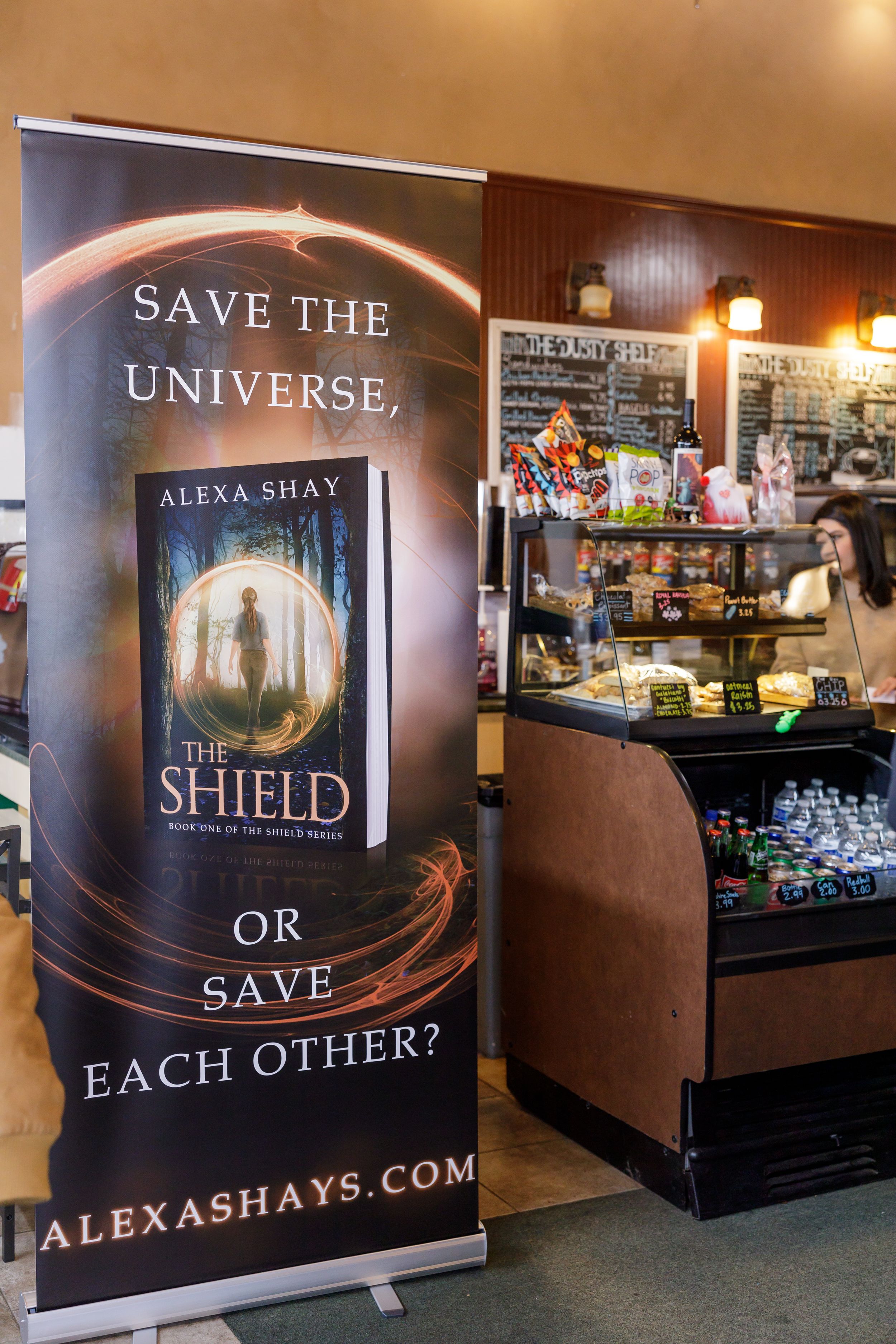 indie book author Alexa Shay author signing event in Enumclaw, WA at Dusty Bookshelf promo book signage by register in bookstore